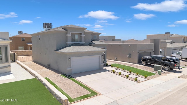 view of side of home with concrete driveway, a residential view, and stucco siding