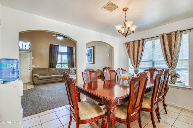 14253 Hacienda Rock Dr, El Paso, TX 79938 - dining space with arched walkways, light tile patterned floors, and a chandelier