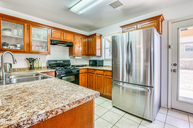 14253 Hacienda Rock Dr, El Paso, TX 79938 - kitchen with black appliances, under cabinet range hood, a sink, and brown cabinetry