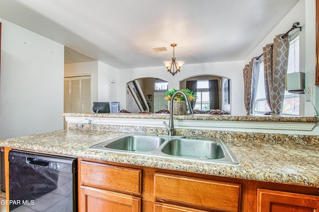 14253 Hacienda Rock Dr, El Paso, TX 79938 - kitchen with a sink, black dishwasher, a chandelier, arched walkways, and brown cabinetry
