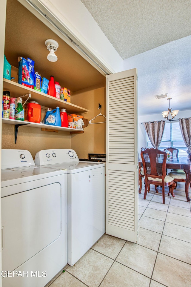 14253 Hacienda Rock Dr, El Paso, TX 79938 - laundry room with washer and dryer, light tile patterned floors, a textured ceiling, and a chandelier