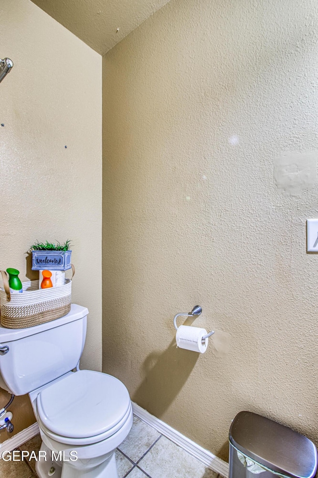 14253 Hacienda Rock Dr, El Paso, TX 79938 - bathroom featuring tile patterned floors, toilet, and baseboards