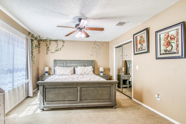 14253 Hacienda Rock Dr, El Paso, TX 79938 - bedroom with light carpet, baseboards, a ceiling fan, and a textured ceiling