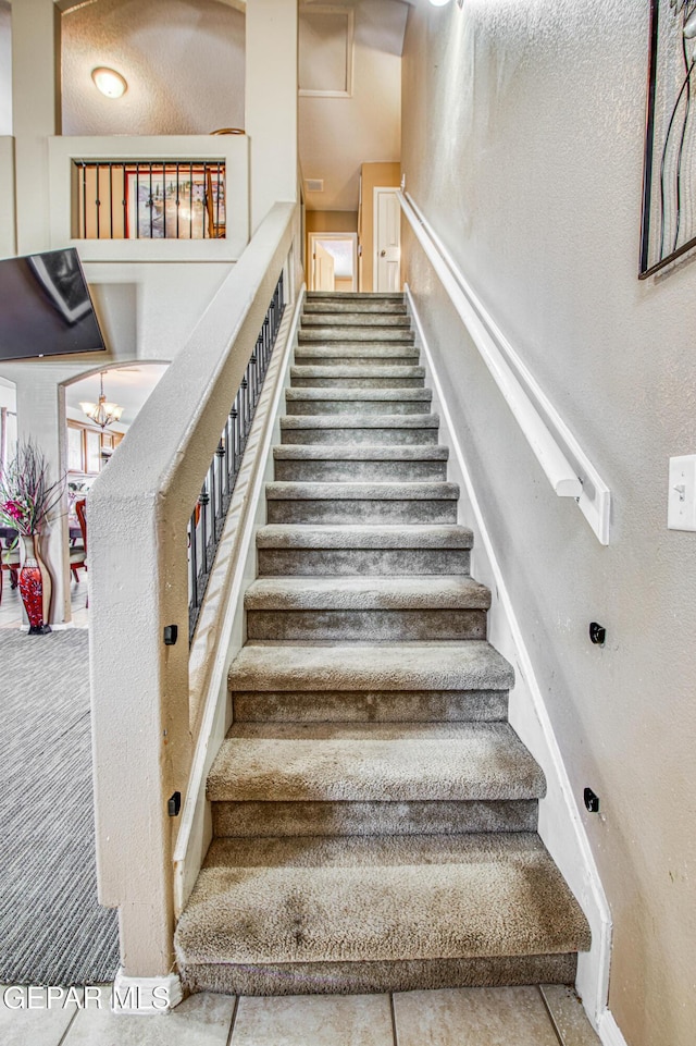 14253 Hacienda Rock Dr, El Paso, TX 79938 - stairway with baseboards and a chandelier