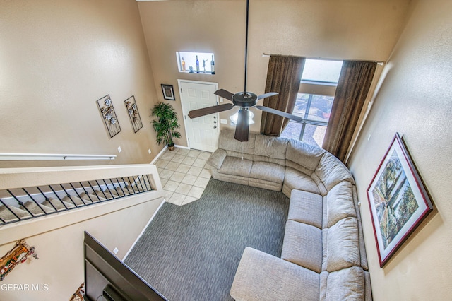 14253 Hacienda Rock Dr, El Paso, TX 79938 - living room featuring ceiling fan, a towering ceiling, tile patterned floors, and baseboards