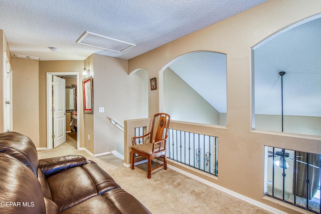 14253 Hacienda Rock Dr, El Paso, TX 79938 - hallway featuring carpet floors, attic access, a textured ceiling, an upstairs landing, and baseboards