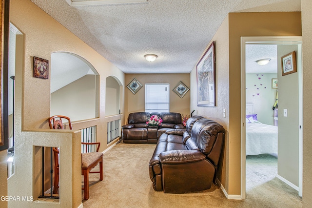 14253 Hacienda Rock Dr, El Paso, TX 79938 - living area with carpet, a textured ceiling, and arched walkways