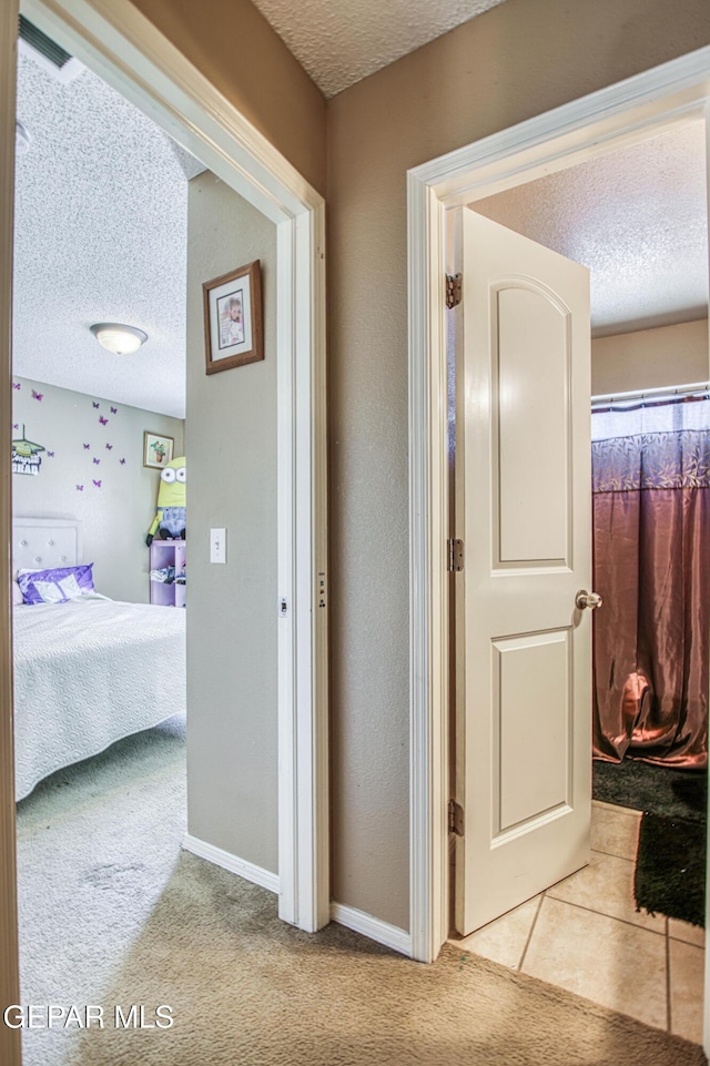 14253 Hacienda Rock Dr, El Paso, TX 79938 - hallway featuring a textured ceiling, carpet flooring, and baseboards