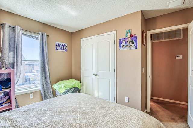 14253 Hacienda Rock Dr, El Paso, TX 79938 - bedroom featuring carpet floors, multiple windows, a textured ceiling, baseboards, and a closet
