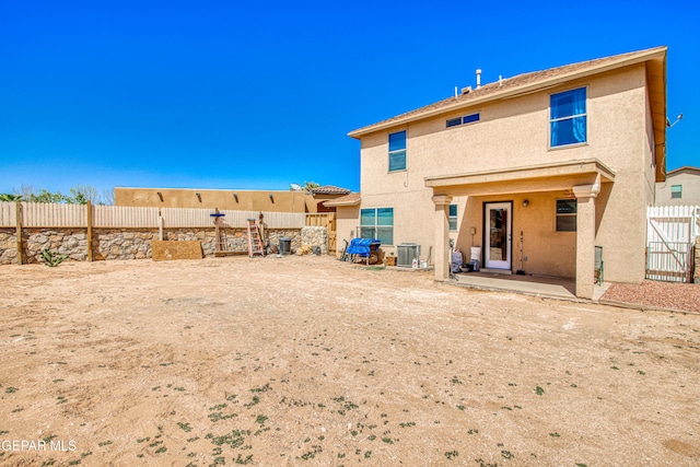 14253 Hacienda Rock Dr, El Paso, TX 79938 - rear view of house with stucco siding, central air condition unit, a fenced backyard, and a patio