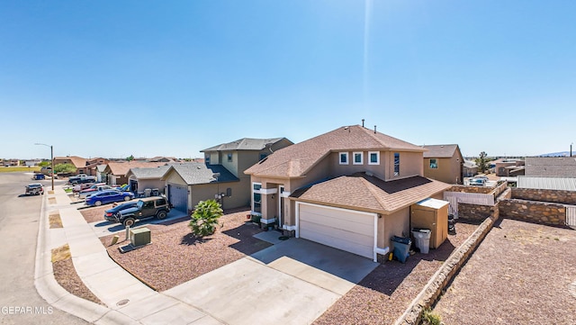 14253 Hacienda Rock Dr, El Paso, TX 79938 - traditional-style home with a residential view, stucco siding, concrete driveway, and a garage