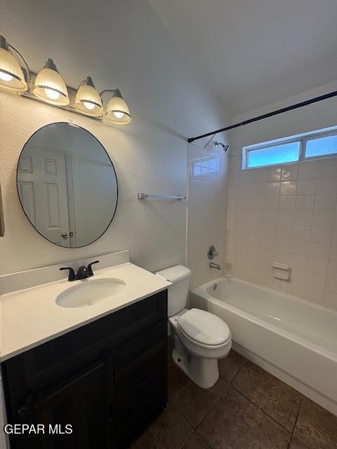 bathroom featuring tile patterned flooring,  shower combination, toilet, and vanity