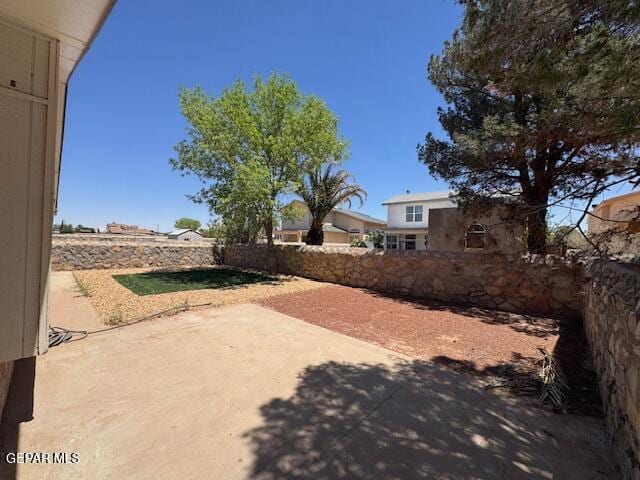 view of yard featuring fence and a patio area