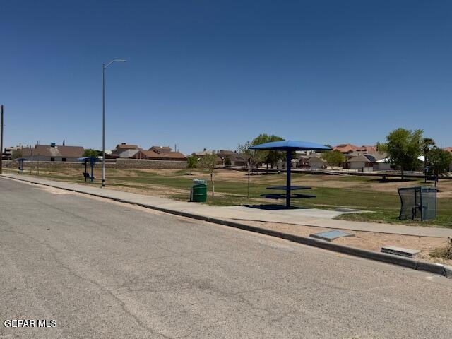 view of street with street lighting, curbs, and sidewalks