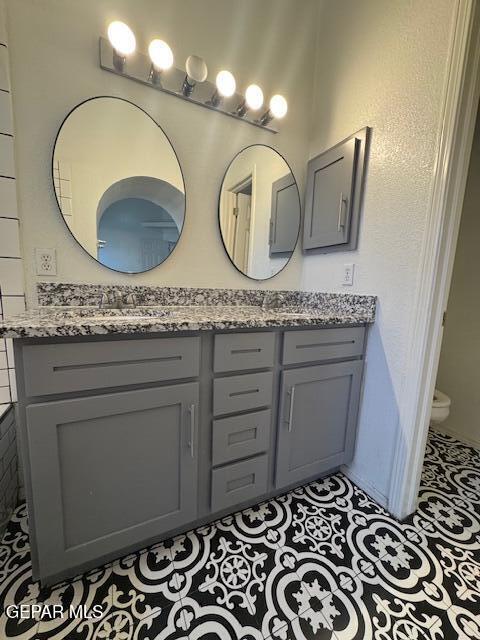 full bath with vanity and toilet