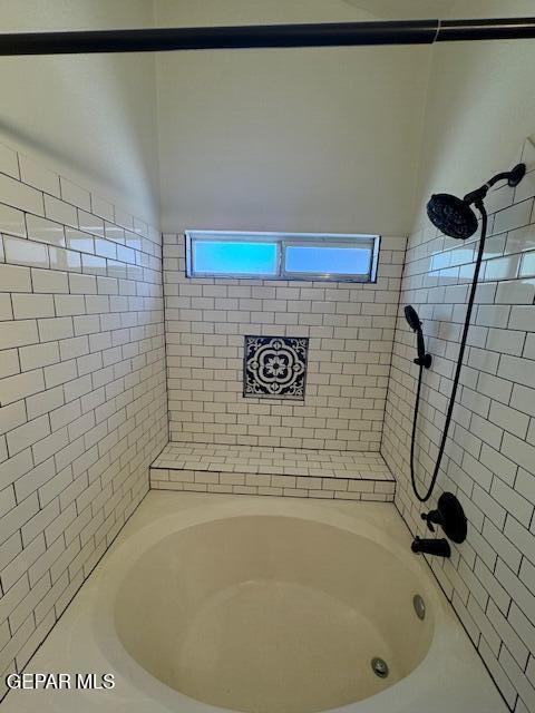 bathroom with shower / tub combination and a healthy amount of sunlight