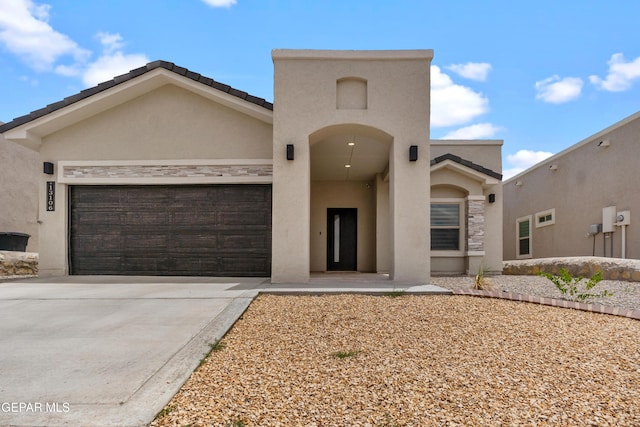 13106 Salterton Ave, El Paso, TX 79928 - mediterranean / spanish house featuring a garage, stucco siding, and concrete driveway