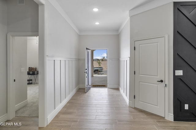 13106 Salterton Ave, El Paso, TX 79928 - hall featuring wainscoting, a decorative wall, light wood-type flooring, visible vents, and ornamental molding