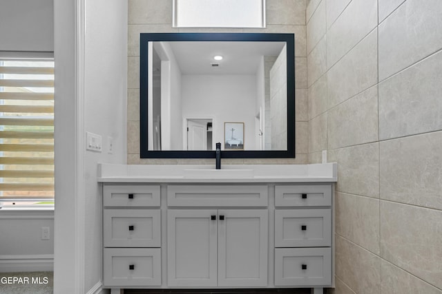 13106 Salterton Ave, El Paso, TX 79928 - bathroom with vanity, visible vents, and tile walls