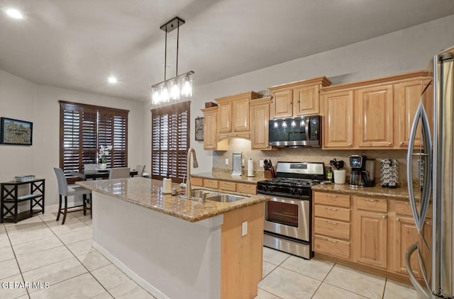 12164 Sitting Bull Dr, El Paso, TX 79936 - kitchen featuring appliances with stainless steel finishes, a sink, light tile patterned floors, decorative backsplash, and light stone countertops
