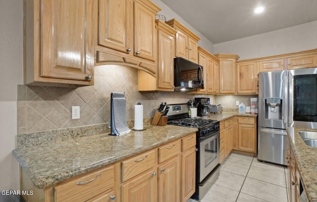12164 Sitting Bull Dr, El Paso, TX 79936 - kitchen featuring appliances with stainless steel finishes, light stone counters, decorative backsplash, and light tile patterned floors