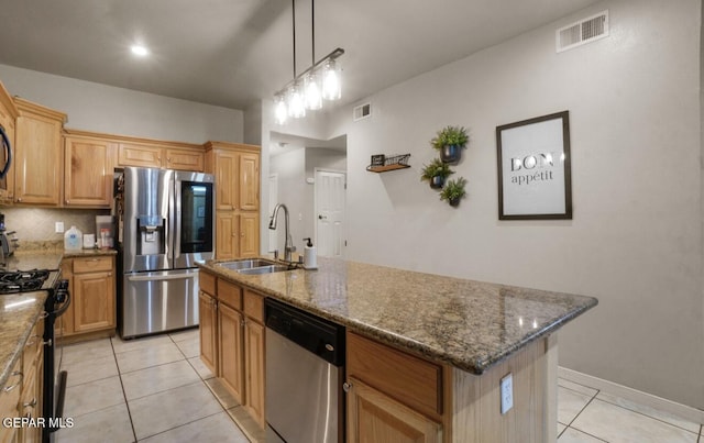 12164 Sitting Bull Dr, El Paso, TX 79936 - kitchen featuring appliances with stainless steel finishes, a sink, light tile patterned floors, a center island with sink, and dark stone countertops