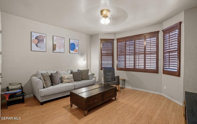 12164 Sitting Bull Dr, El Paso, TX 79936 - living room featuring light wood-style floors, a ceiling fan, and baseboards