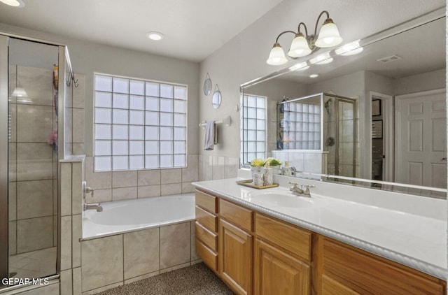 12164 Sitting Bull Dr, El Paso, TX 79936 - full bath featuring a stall shower, a bath, vanity, and a chandelier