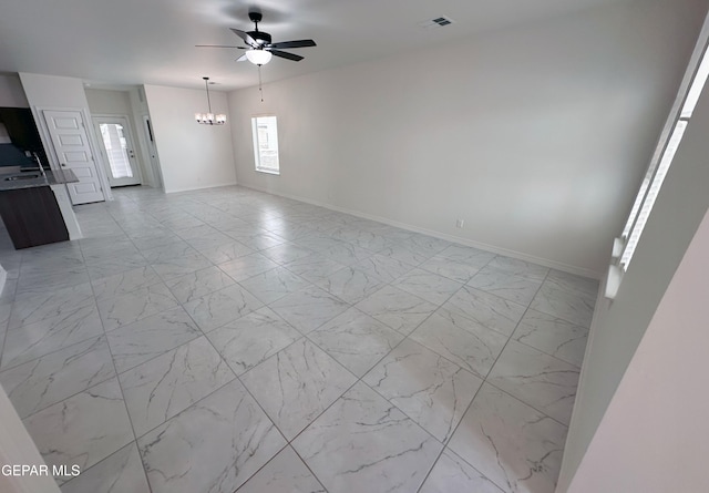 913 Larkhall Pl, El Paso, TX 79928 - unfurnished living room with baseboards, ceiling fan with notable chandelier, marble finish floor, and visible vents
