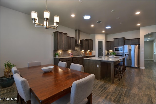 dining room with recessed lighting, dark wood finished floors, a notable chandelier, and visible vents