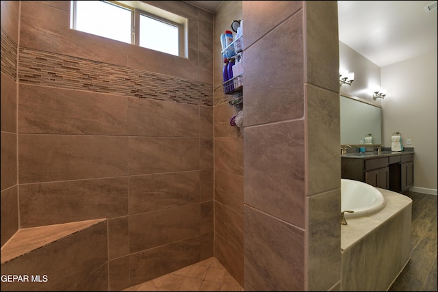 bathroom featuring vanity, a tile shower, a bath, and wood finished floors