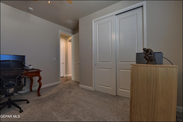 office space with carpet flooring, baseboards, and visible vents