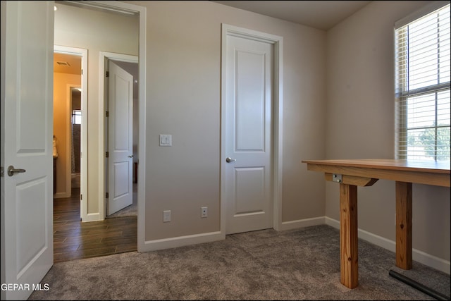 unfurnished bedroom with baseboards and carpet