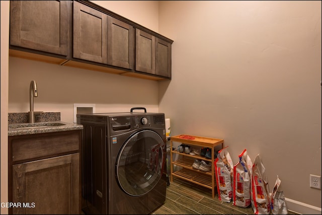 laundry room featuring washer / dryer, baseboards, dark wood-type flooring, a sink, and cabinet space