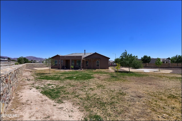 back of house featuring fence