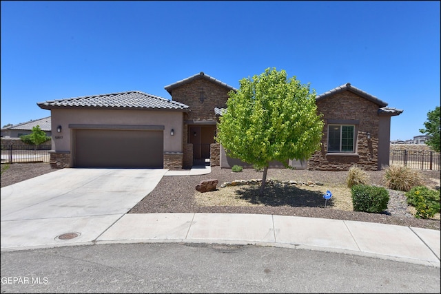 view of front of property with fence, stone siding, a garage, stucco siding, and a tiled roof