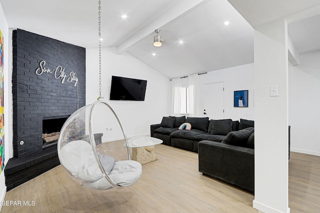 living room with vaulted ceiling with beams, baseboards, wood finished floors, and a fireplace
