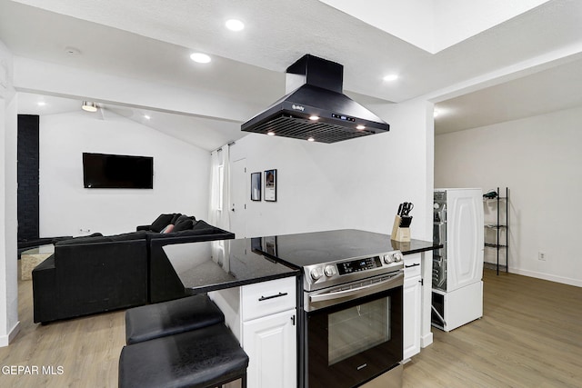 kitchen with exhaust hood, electric range, light wood-style flooring, and lofted ceiling