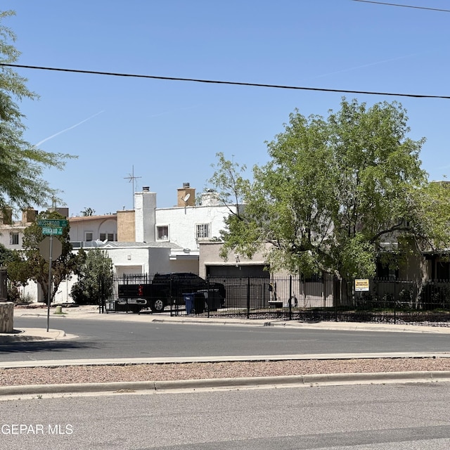 view of road with traffic signs, sidewalks, and curbs