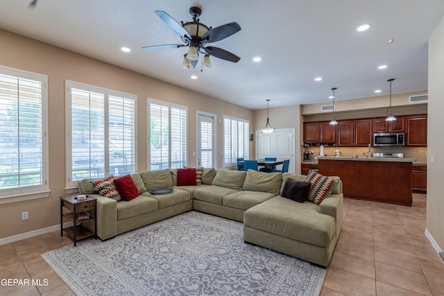 living room with a ceiling fan, visible vents, light tile patterned floors, baseboards, and recessed lighting