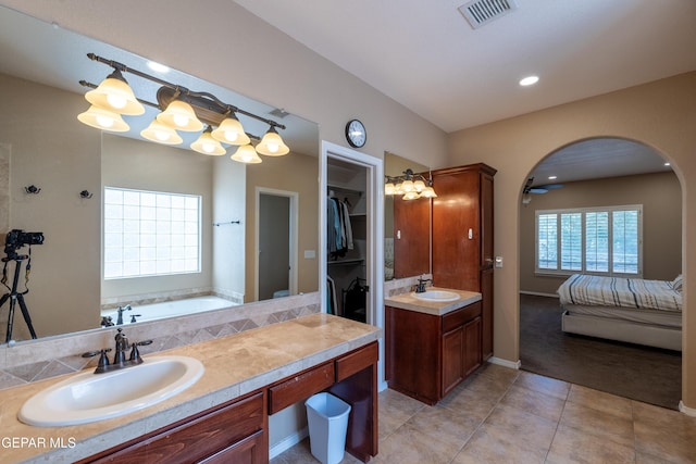 ensuite bathroom featuring visible vents, tile patterned flooring, vanity, a bath, and ensuite bath