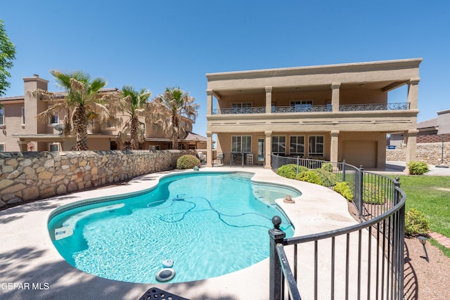 view of swimming pool featuring a fenced in pool, a patio area, and fence