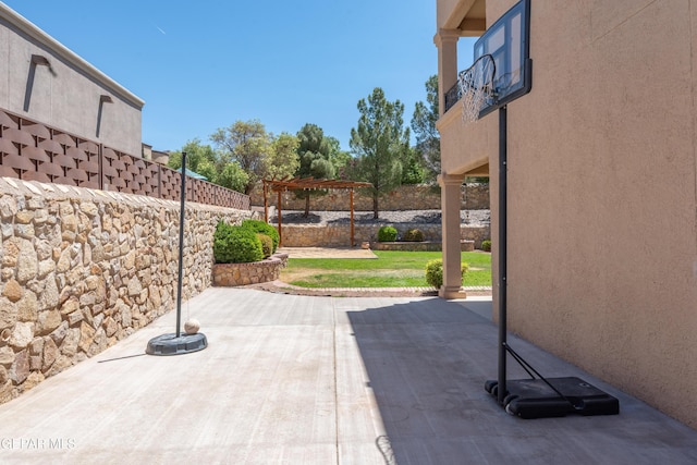 view of patio / terrace with fence and a balcony