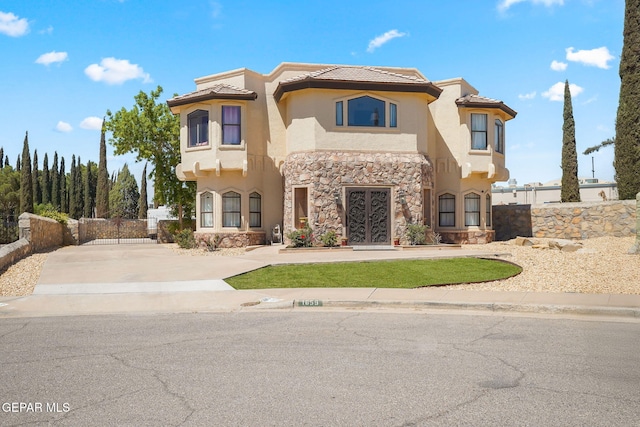 1859 Luis Gomez Place, El Paso, TX 79936 - view of front of house featuring stucco siding, stone siding, a tiled roof, and fence