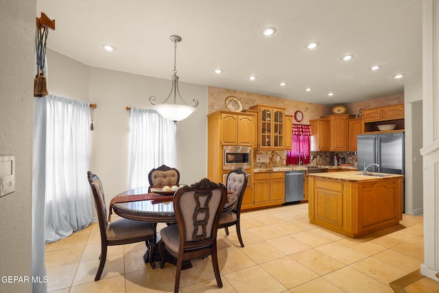 1859 Luis Gomez Place, El Paso, TX 79936 - kitchen with stainless steel appliances, light countertops, recessed lighting, a kitchen island with sink, and decorative backsplash