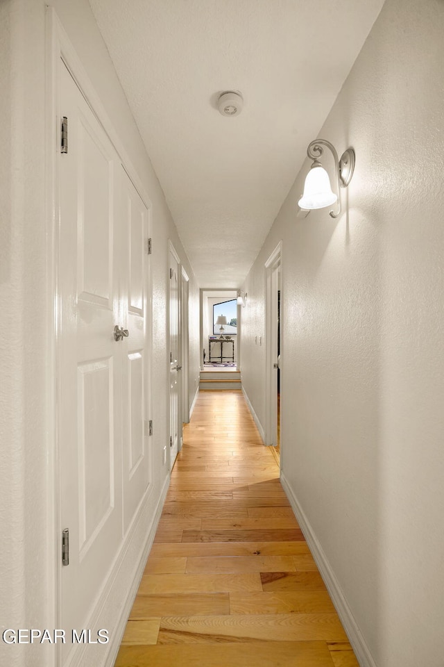 1859 Luis Gomez Place, El Paso, TX 79936 - hallway featuring light wood-type flooring and baseboards