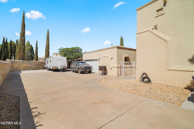 1859 Luis Gomez Place, El Paso, TX 79936 - view of side of property featuring stucco siding, fence, a garage, and brick siding