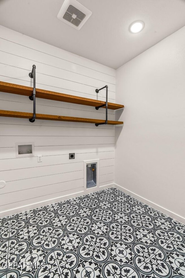 clothes washing area with laundry area, electric dryer hookup, visible vents, baseboards, and hookup for a washing machine