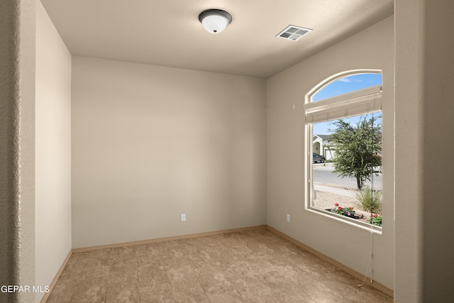 empty room with baseboards and visible vents