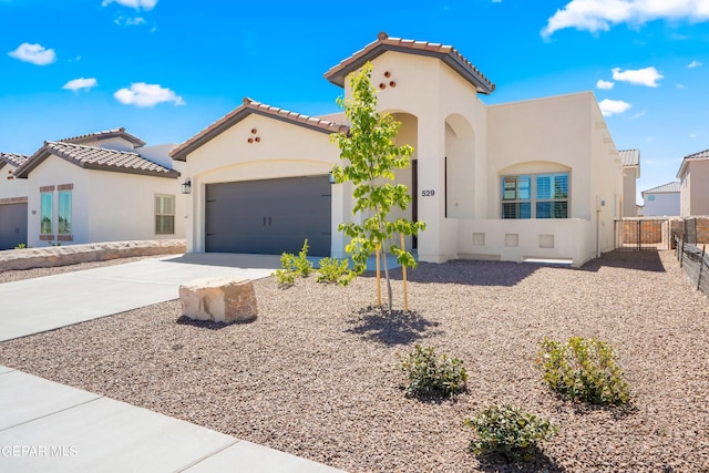 921 Raegil St, El Paso, TX 79928 - mediterranean / spanish home with driveway, stucco siding, a garage, and a tile roof